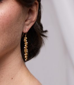 model wearing gold vermeil earrings