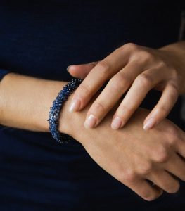 Sapphire and silver bracelet modelled by a woman's hands