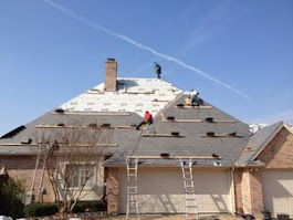 JDCC Roofing crew performing a residential roof replacement on a two-story home in Weatherford, TX, with shingles being removed and new underlayment installed