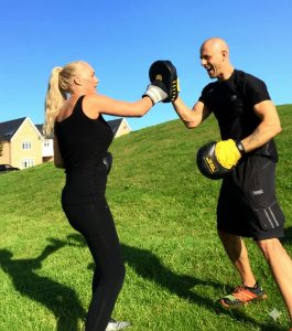 a photo showing Andy training outside with a female client 