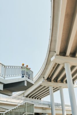 Modern highway overpass with structural supports and safety railings.