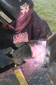 Image of a welder from Jolson Welding, welding with a Dura-Flux MIG gun