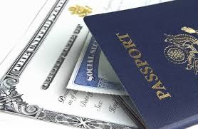 A blue United States passport resting on top of a Social Security card and official documents.