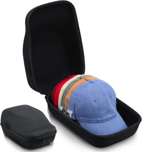 A collection of colorful hats packed inside a black travel case, showcasing organized accessories for travel or outdoor activities.