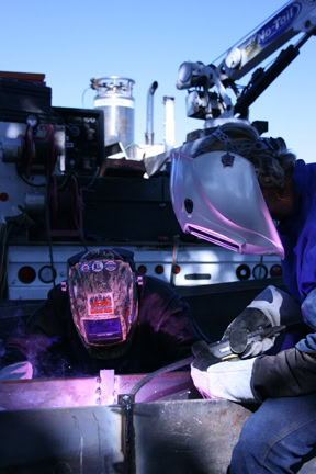 Image of two welders on a jobsite, welding in a flux cored application