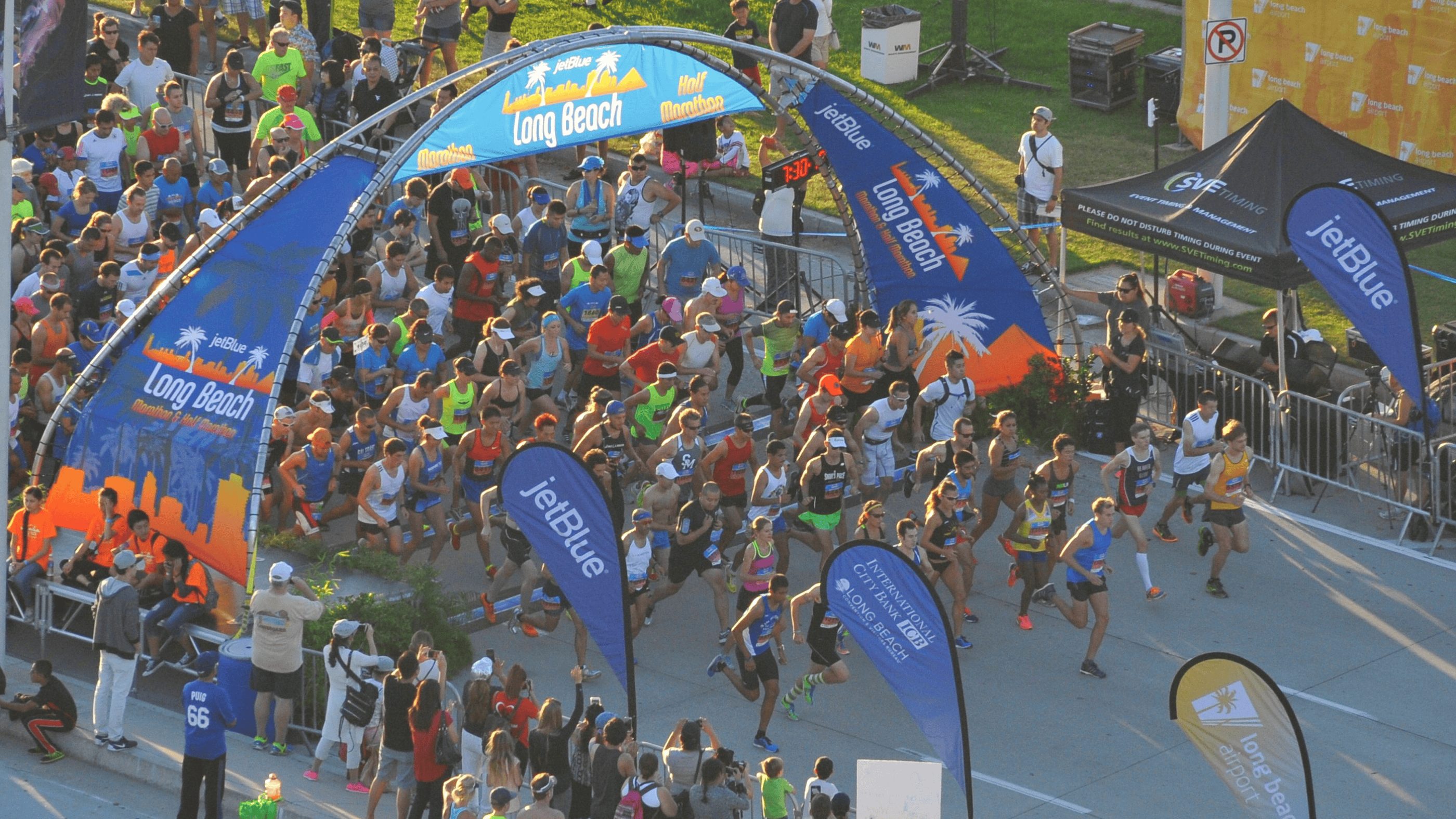 Runners crossing the starting line at the Long Beach Marathon, kicking off the race with excitement and energy.