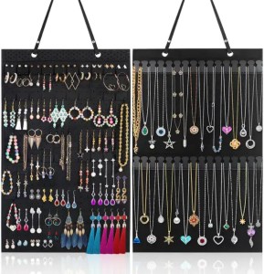 Colorful array of jewelry including earrings, necklaces, and pendants displayed on black jewelry boards. Perfect for accessorizing and gift-giving at Soulstice Living.