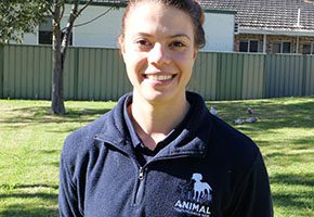 Brunette woman in AWL fleece smiling at camera