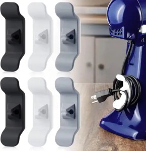 Black, white, and gray cord organizer clips for kitchen appliances and cable management.