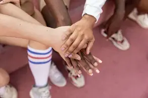 Picture of hands on top of each other representing the impact of generational trauma on communities. Start trauma therapy in detroit mi now.