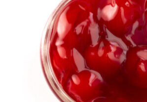 A Glass Canning Jar Filled with Cherry Pie Filling Isolated on a White Background