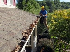 Removing debris from eavestrough London Ontario