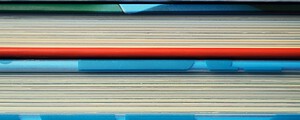 services-02 Close-up image of colorful hardcover books stacked in a pattern.