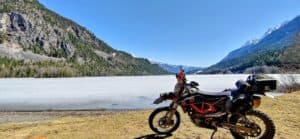 a picture of a frozen summit lake with motorcycle