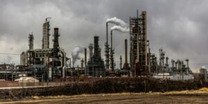 Image of a large factory with several chimneys with a grey sky in the background, used to show pyrolysis.