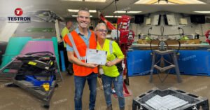 Testron Technician Handing over training certificate for TT-UL6 Falling Weight Impact Tester