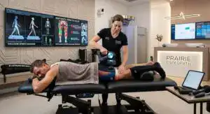 Therapist Performing deep Tissue Release Therapeutic Treatment witj Massage gun followed by hot water hydrotherapy