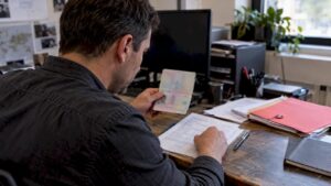 Investigator verifying passport details against a source record