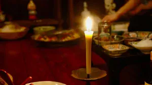 candle lighting a table of food