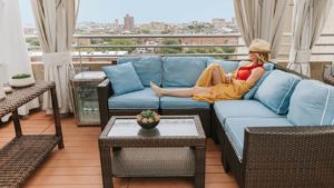 Woman enjoying the comfortable poolside Cabana at The Colonnade Boston.