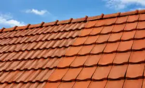 Close-up of roof tiles on a sloped roof under a blue sky