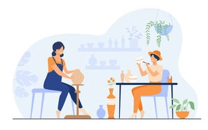 Smiling female artists creating ceramic vase from clay