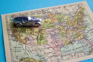 miniature-silver-racer-heading-east-on-a-miniature-vintage-map-of-the-united-states-of-america_t20_-Envato
