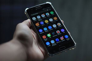 Close-up of a smartphone showcasing various mobile applications on its display.