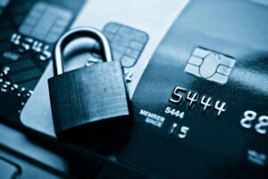 closed lock on top of a stack of credit cards, monotone