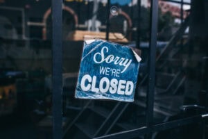Inscription on a door: Sorry we are closed. Conceptual photo or table on door with information of work. Announcement or work schedule