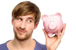 Young man holding piggybank
