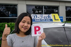 A professional D-Tech driving instructor helping a student master car control during a local driver training session.