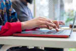 person typing on computer. Begin trauma therapy in michigan