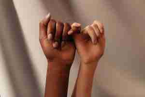 two hands with linked pinky fingers. Start LGBTQ friendly therapy near me.