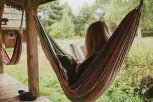 A woman relaxes on a hammock, the kind of calm a somatic therapist in Farmington Hills helps you reconnect with.