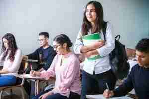 Students sit in a classroom, where OCD can disrupt focus without obsessive compulsive disorder counseling support.