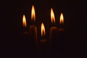 a group of lit candles in the dark