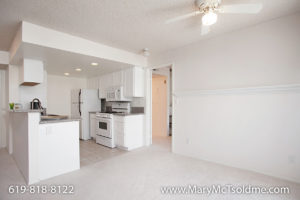 Bright kitchen and dining area at 4205 Ohio Street featuring white cabinetry, granite countertops, a gas range, and a white ceiling fan.