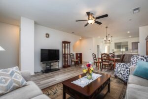 Tri-level home's open-concept living area at 5235 Beachfront Cove Unit 102, featuring designer ceiling fans and a seamless flow into the upgraded kitchen.