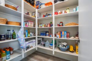 Spacious walk-in pantry at 5235 Beachfront Cove Unit 102 with extensive built-in shelving and ample storage for a modern lifestyle