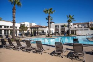 Wide-angle view of the resort-style pool and spa area at the Playa Del Sol recreation center