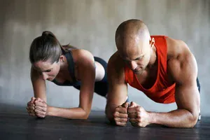 man and woman in a high plank position