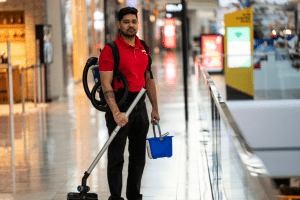 amc cleaners in uniform and with cleaning equipment at shopping mall site 