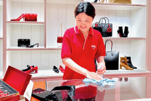 AMC cleaner at Retail luxury store cleaning display area fingermark on glass shelves and mirrow