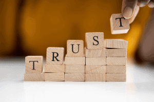 building blocks with the word "trust" spelled out