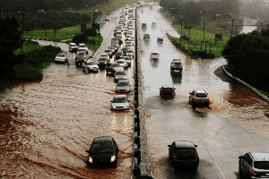 cars driving through flooded streets