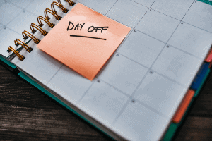work calendar with a post it that reads "day off"