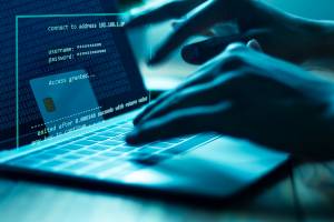 typing on laptop to access credit card