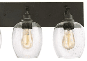 Eldon 3-light wall-mounted vanity fixture in oil rubbed bronze with highlights and clear seeded glass shades, 24-inch length, industrial modern farmhouse style