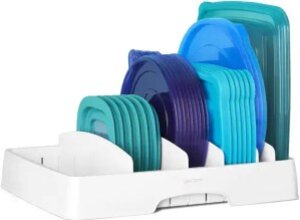 Colorful silicone food storage lids in various sizes and colors, eco-friendly kitchen organization tools, reusable food covers for freshness and sustainability, displayed in a white storage rack.